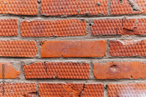 background of red textured relief brick. aged old stone wall or street texture blocks as backdrop closeup. pattern architecture construction design