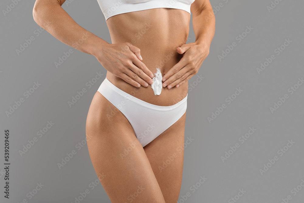 © Prostock-studio - Body Care. Slim Sporty Woman Applying Moisturising Lotion On Belly Area © Prostock-studio - Body Care. Slim Sporty Woman Applying Moisturising Lotion On Belly Area