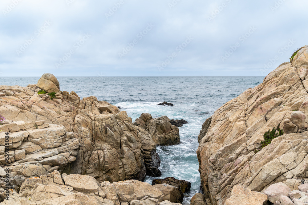 California, USA - May 18, 2018: gap between two giant rocks against blue sky on the ocean. coastal scenery along Pacific coast highway in united states California, USA - May 18, 2018: gap between two giant rocks against blue sky on the ocean. coastal scenery along Pacific coast highway in united states