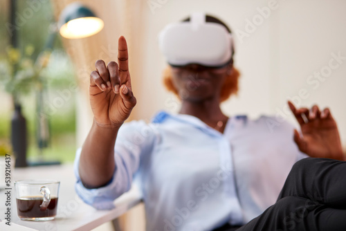 Woman Working From Home Office Sitting At Desk Wearing VR Headset Interacting With AR Technology