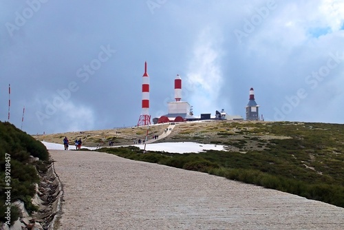 Senderistas subiendo a la cima de la montaña de La Bola del Mundo o Alto de las Guarramillas en Madrid (España). Antenas cuya función era la repetición de la emisión de la señal de radio y televisión. photo