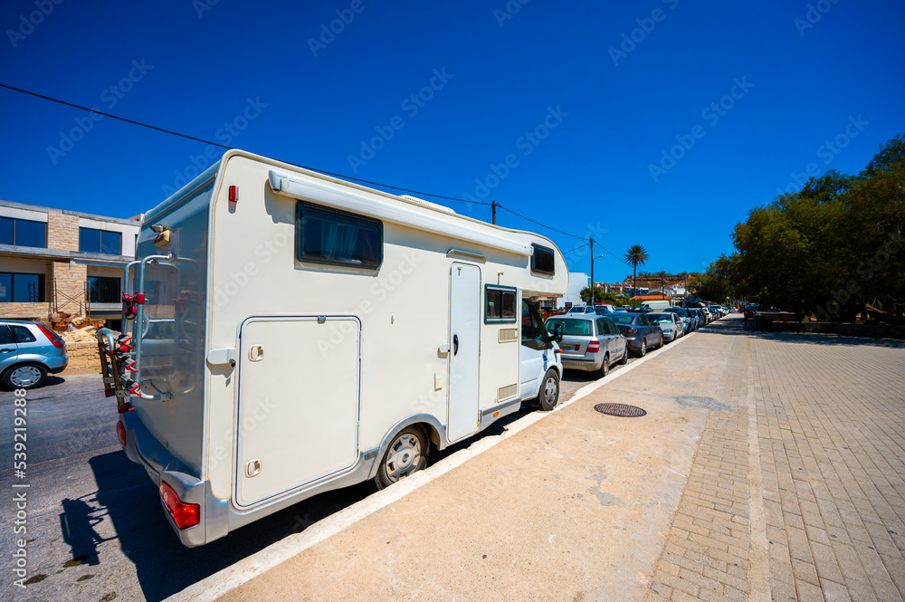 Motorhome  parked in public parking on the street in Paleochora.