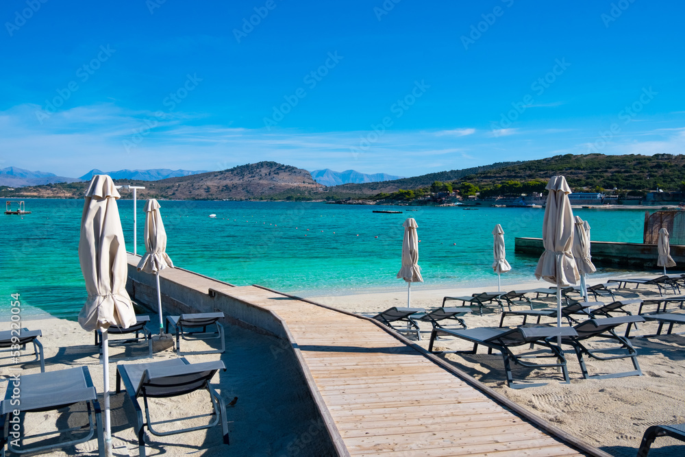 Beach with umbrellas and deck chairs in Ksamil in Albania