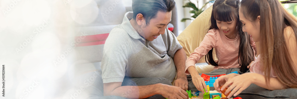 web banner Asian family portrait There are parents and daughters playing block puzzles at home together having fun and happiness with modern tools with copy space on left web banner Asian family portrait There are parents and daughters playing block puzzles at home together having fun and happiness with modern tools with copy space on left