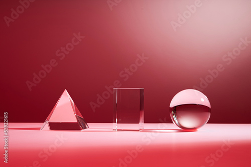 Crystal glass shapes on a pink gradient background. Minimal scene with podium. photo