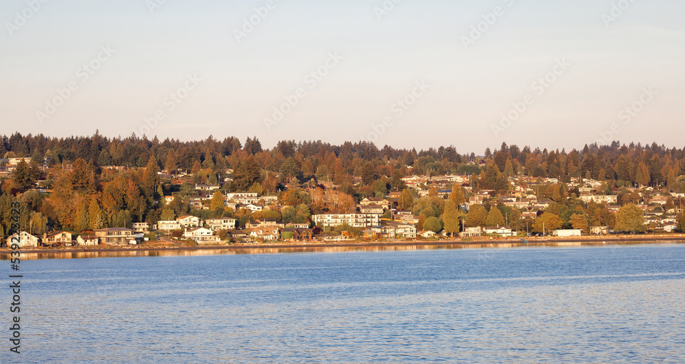 Residential Homes by the Ocean in the City of Nanaimo during a sunny summer day. Taken in Vancouver Island, British Columbia, Canada.