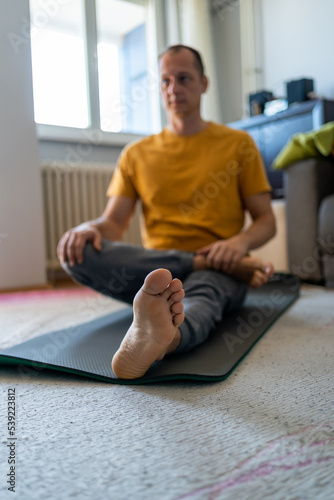 Middle-aged man working out doing stretches of legs