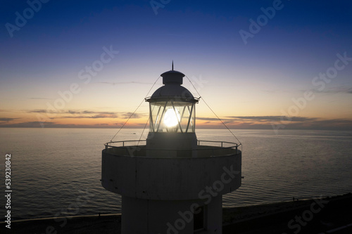 Aerial view of a maritime lighthouse taken at night