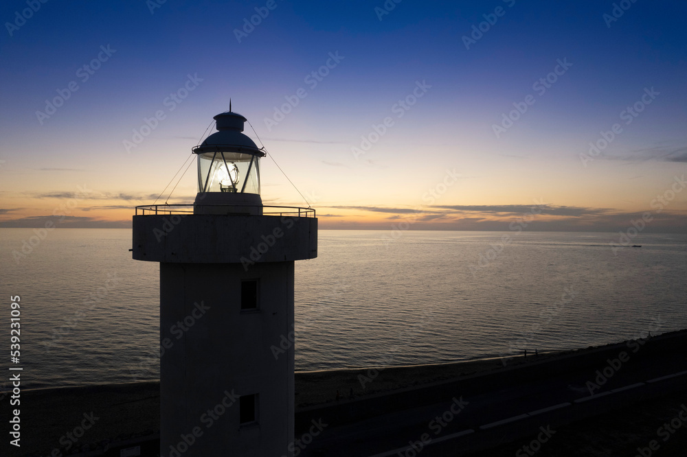 Aerial view of a maritime lighthouse taken at night