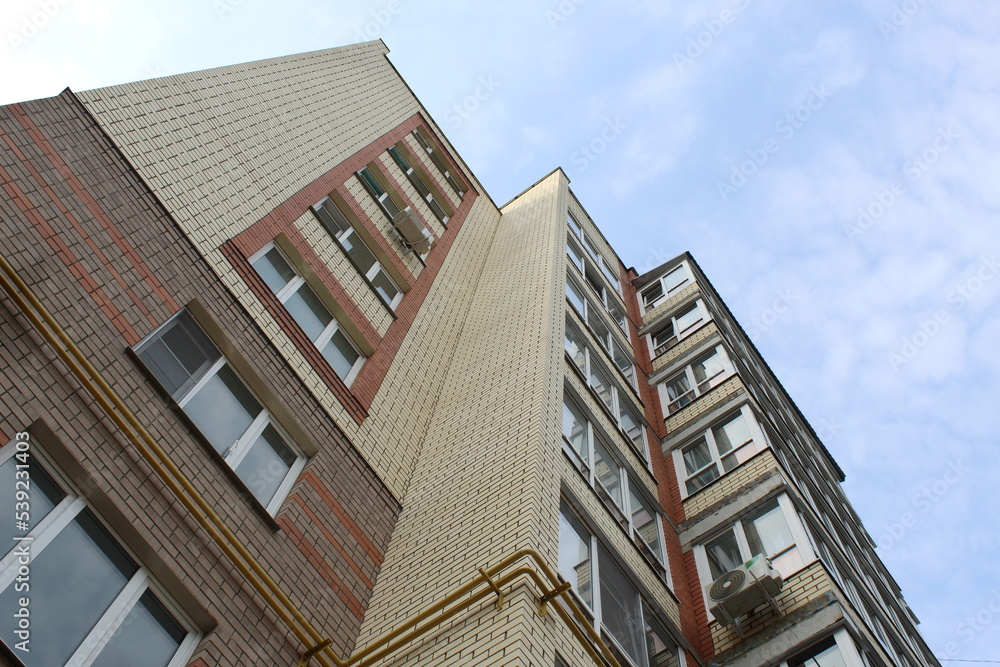 A multi-story building shot from the bottom up against the sky. A multi-story building shot from the bottom up against the sky.