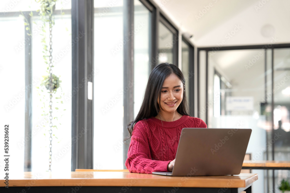 Young asian businesswoman beautiful charming smiling and using laptop computer in office. Young asian businesswoman beautiful charming smiling and using laptop computer in office.