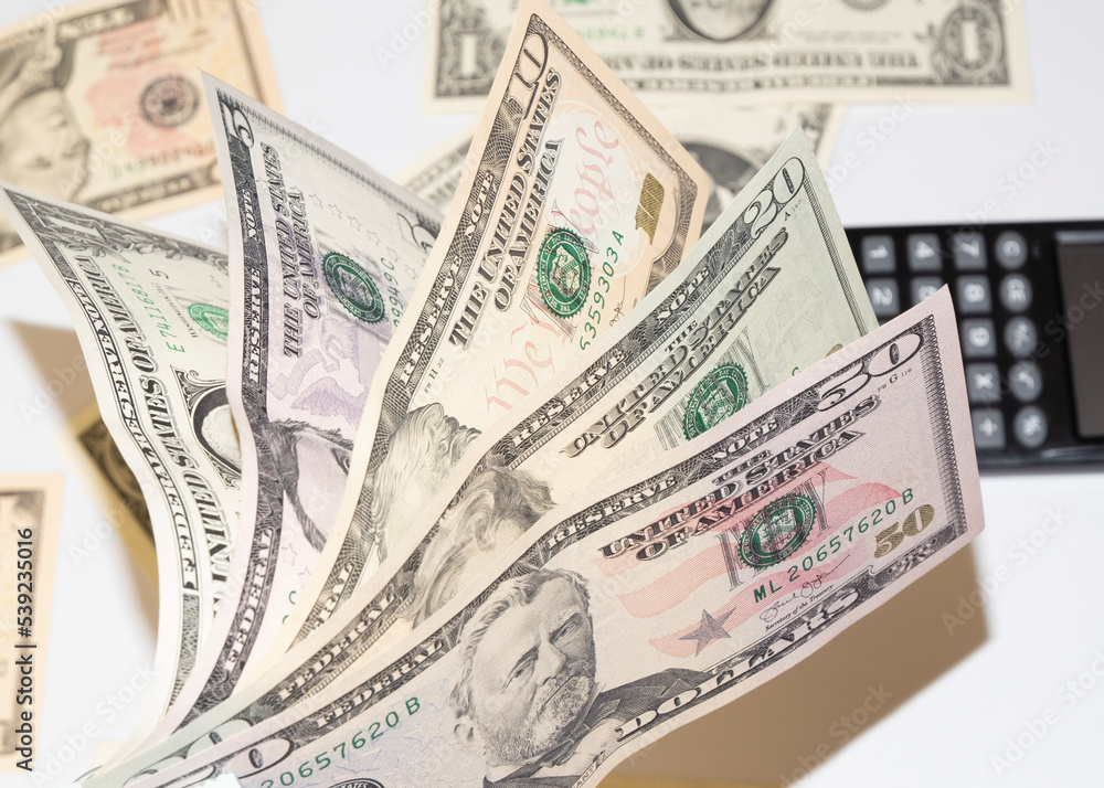 Canculator on the photo of money. calculate the cost of a car trip Canculator on the photo of money. calculate the cost of a car trip