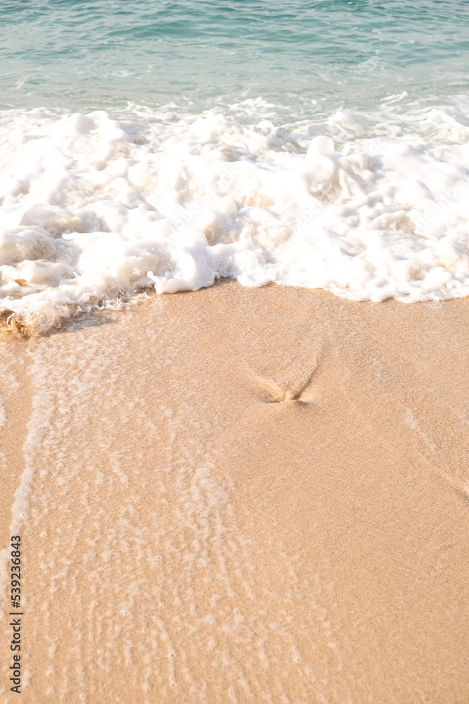 Top view of sand sea and wave. Holiday concept with sea and sand. Sea foam and sand. Holiday phone screen background.