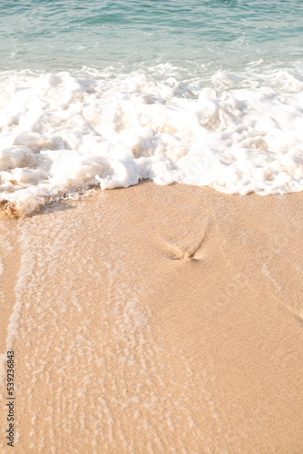 Fototapeta Naklejka Na Ścianę i Meble -  Top view of sand sea and wave. Holiday concept with sea and sand. Sea foam and sand. Holiday phone screen background.