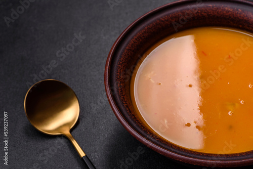 Delicious hot pumpkin and carrot soup puree with spices and herbs