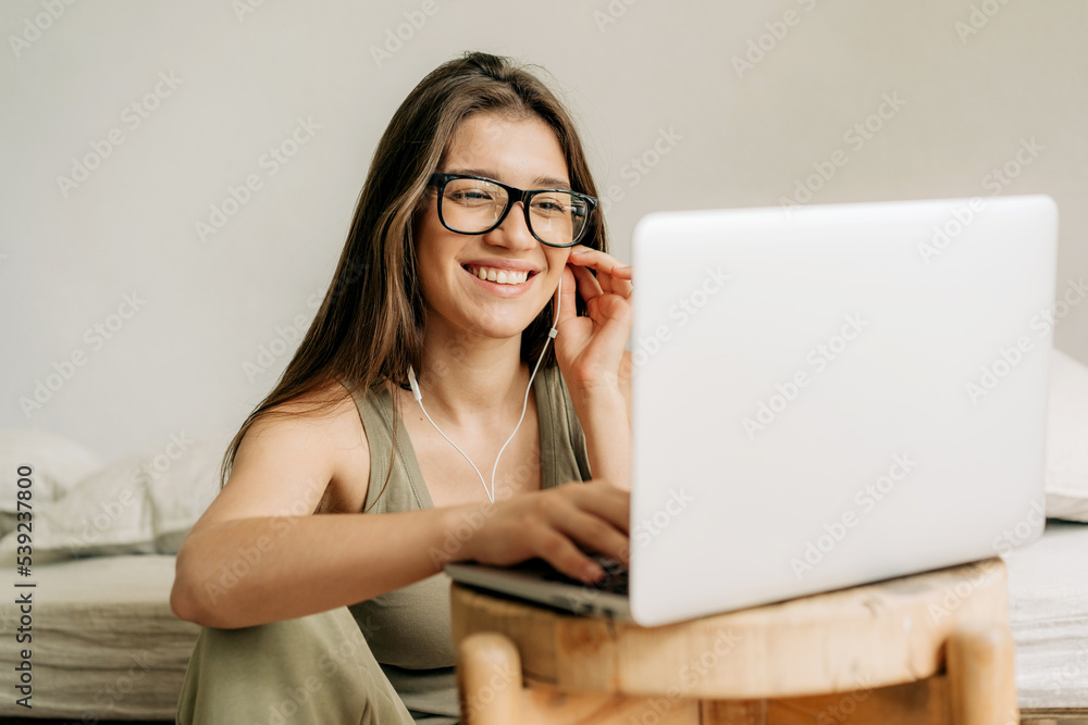 Freelancer woman at online meeting using laptop and headphones. Freelancer woman at online meeting using laptop and headphones.