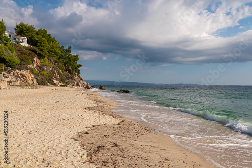 Panoramic view on the Fava sand beach near Vourvourou  Greek peninsula Sithonia  Chalkidiki  Halkidiki   Greece  Europe. Summer vacation at Aegean Mediterranean Sea. Luxury seaview apartment on cliff