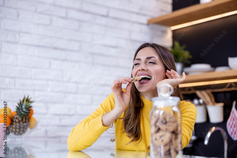 Beautiful young woman eating cookies Beautiful young woman eating cookies