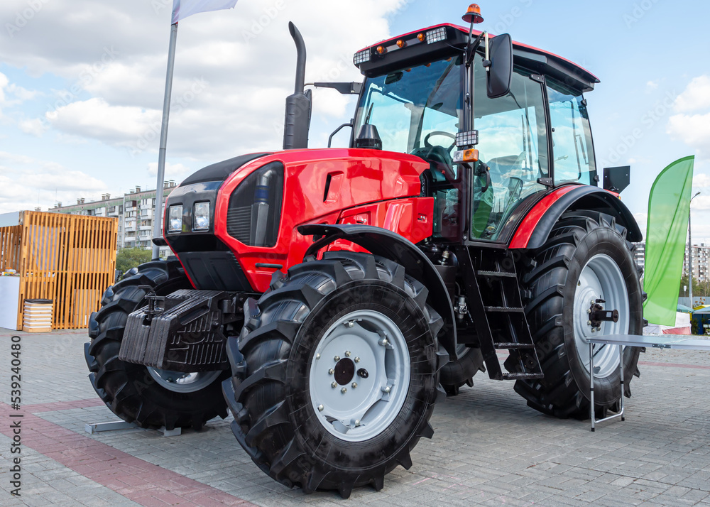 Red wheeled tractor at an agricultural fair Red wheeled tractor at an agricultural fair