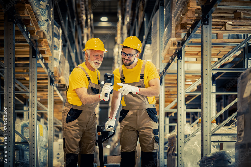 Fototapeta premium Warehouse workers scanning barcodes in warehouse