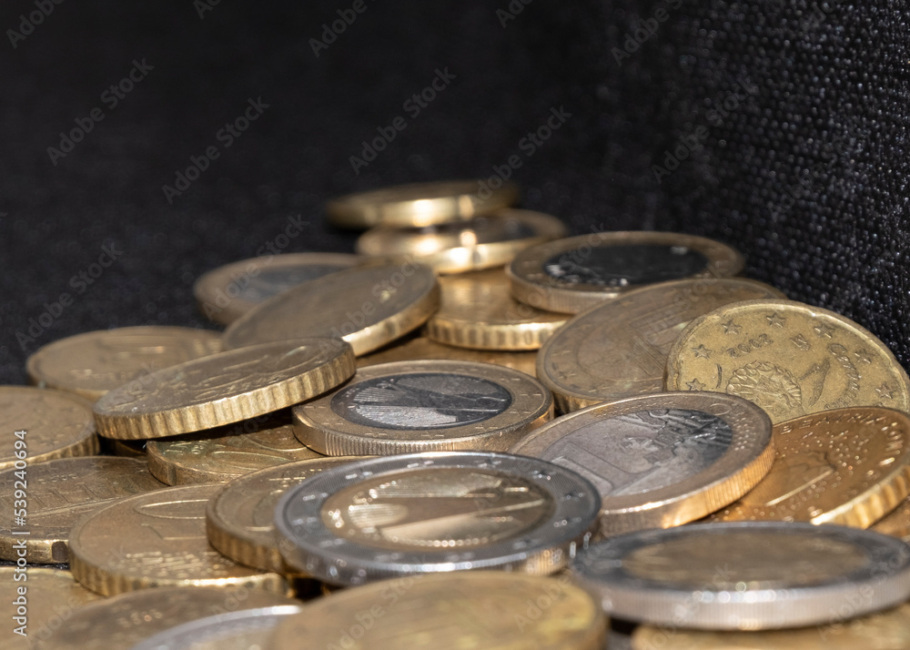 euro coins of different denominations on a dark background euro coins of different denominations on a dark background