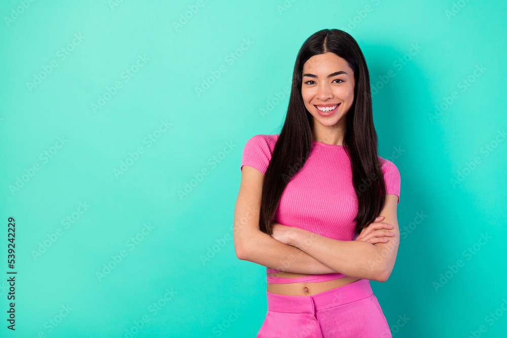 Photo of adorable lady clothes designer with folded arms wear her new collection costume isolated on teal color background Photo of adorable lady clothes designer with folded arms wear her new collection costume isolated on teal color background