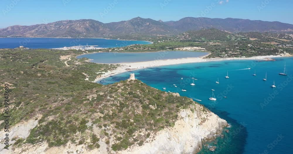 Aerial view of Spiaggia di Porto Giunco, a beautiful bay near a 17th century watchtower, The Aragonese Tower of Porto Giunco, in Sardinia, Italy Aerial view of Spiaggia di Porto Giunco, a beautiful bay near a 17th century watchtower, The Aragonese Tower of Porto Giunco, in Sardinia, Italy