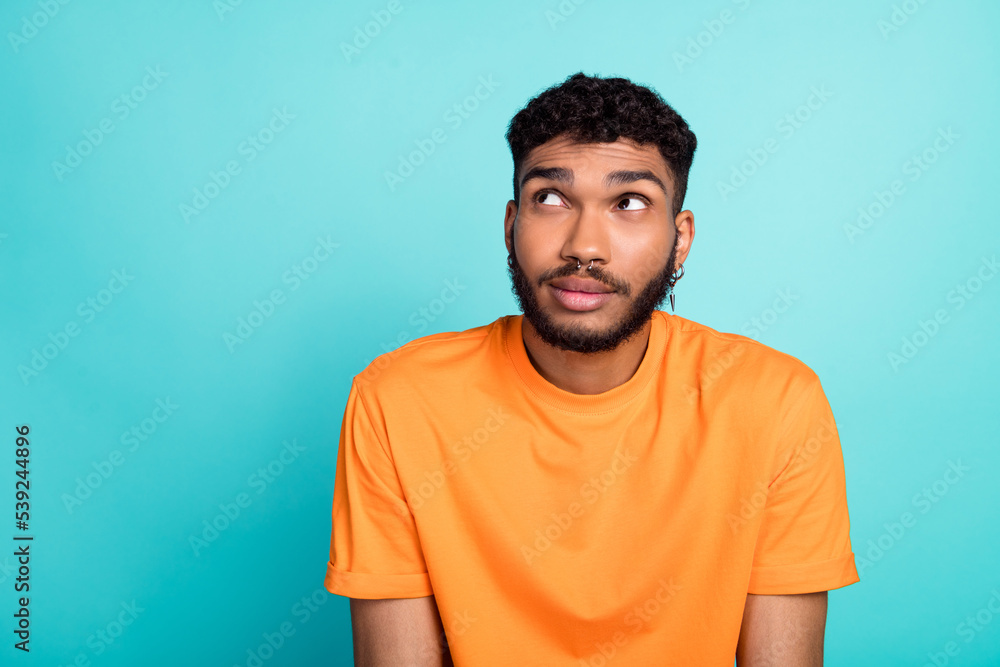 Photo of minded creative person look interested empty space contemplate isolated on teal color background Photo of minded creative person look interested empty space contemplate isolated on teal color background