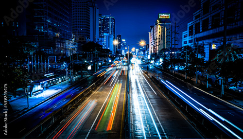 The light of cars running against each other with a low shutter shot in the middle of the capital Bangkok Thailand 