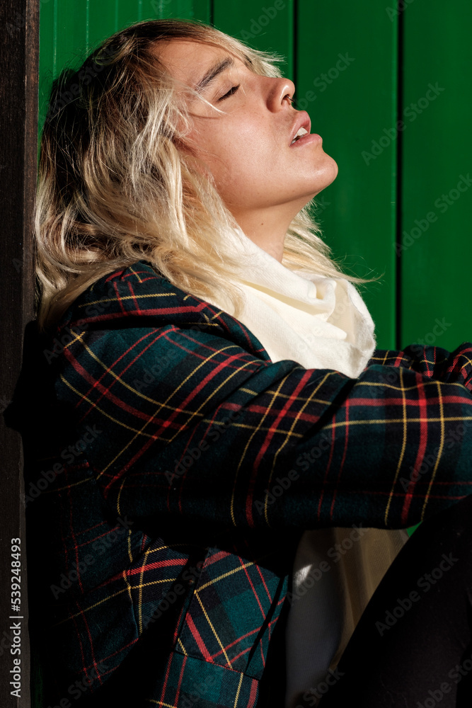 Fototapeta premium Young alternative woman enjoying the sun with closed eyes.