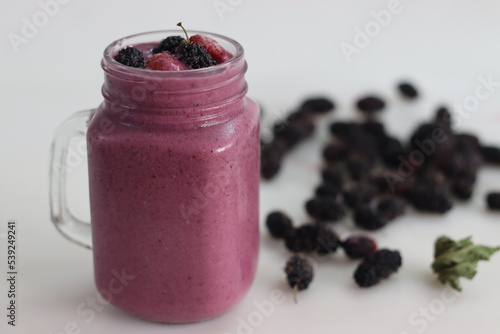 Mixed berry smoothie. Thick and creamy smoothie made of fresh strawberry and mulberry in almond milk. Served in smoothie jar