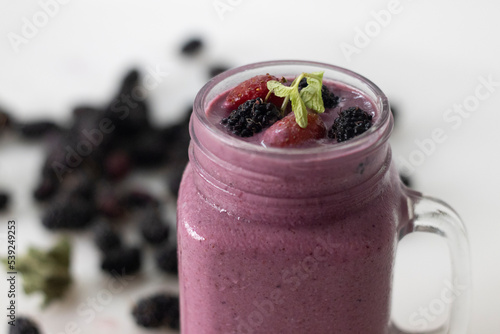 Mixed berry smoothie. Thick and creamy smoothie made of fresh strawberry and mulberry in almond milk. Served in smoothie jar
