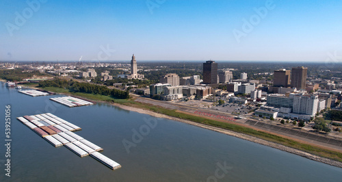 Baton Rouge State Capitol Louisiana city Mississippi River levee tug boats mid angle afternoon