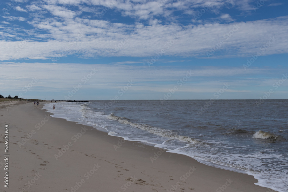 The ocean is beating the shore here. There was a hurricane off the coast at the time that produced some rough waves. I love the blue sky with patched of clouds. This was at Cape May New Jersey. The ocean is beating the shore here. There was a hurricane off the coast at the time that produced some rough waves. I love the blue sky with patched of clouds. This was at Cape May New Jersey.