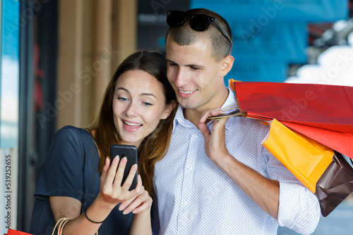 attractive young couple doing selfi after shopping