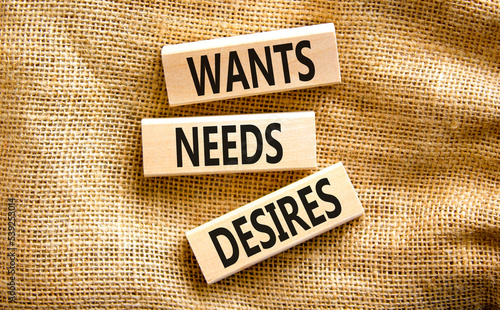Wants needs and desires symbol. Concept words Wants Needs Desires on wooden blocks. Beautiful canvas table canvas background. Business, psychological wants needs and desires concept. Copy space.
