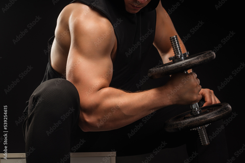 Strong professional weightlifter lifting a dumbbell Strong professional weightlifter lifting a dumbbell