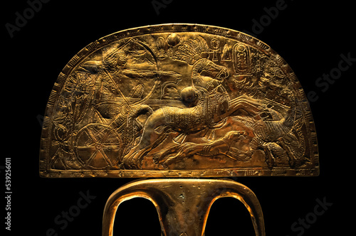 golden artifact from Egypt with chariot rider