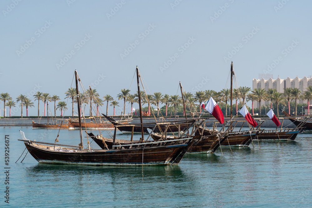 Traditional arabian dhows with Qatar flags in Doha , Qatar.