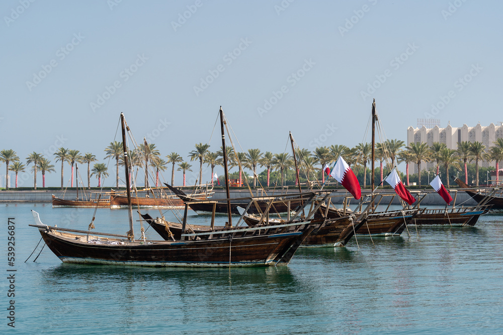 Traditional arabian dhows with Qatar flags in Doha , Qatar. Traditional arabian dhows with Qatar flags in Doha , Qatar.