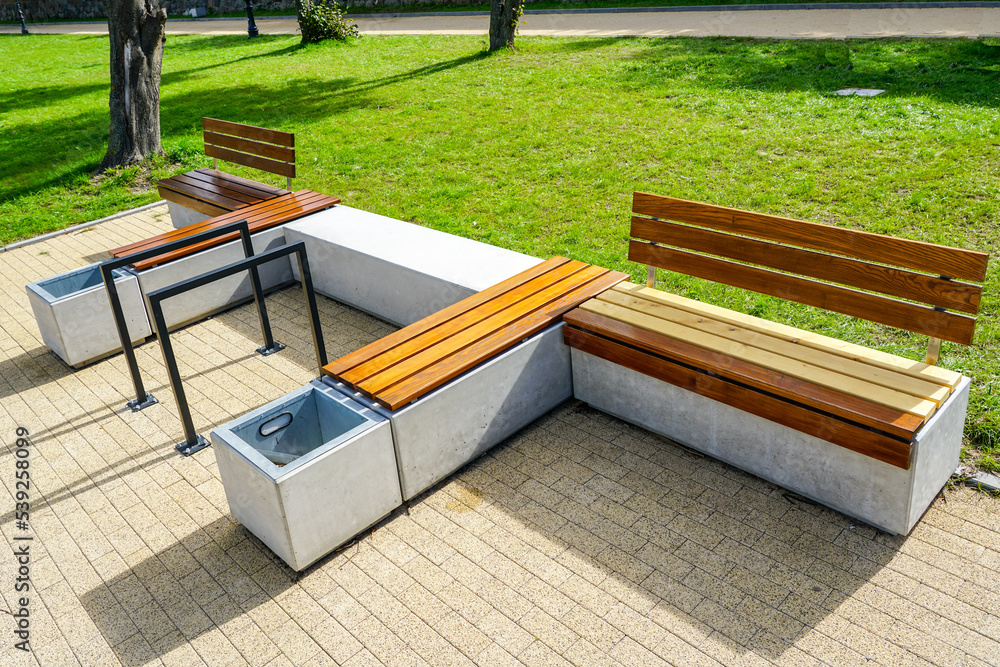 New modern design outdoor infrastructure object, wooden plank rest benches with a concrete base - obrazy, fototapety, plakaty 