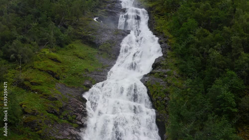 beautiful norwegian waterfall among green forest. Aerial shot. beautiful norwegian waterfall among green forest. Aerial shot.