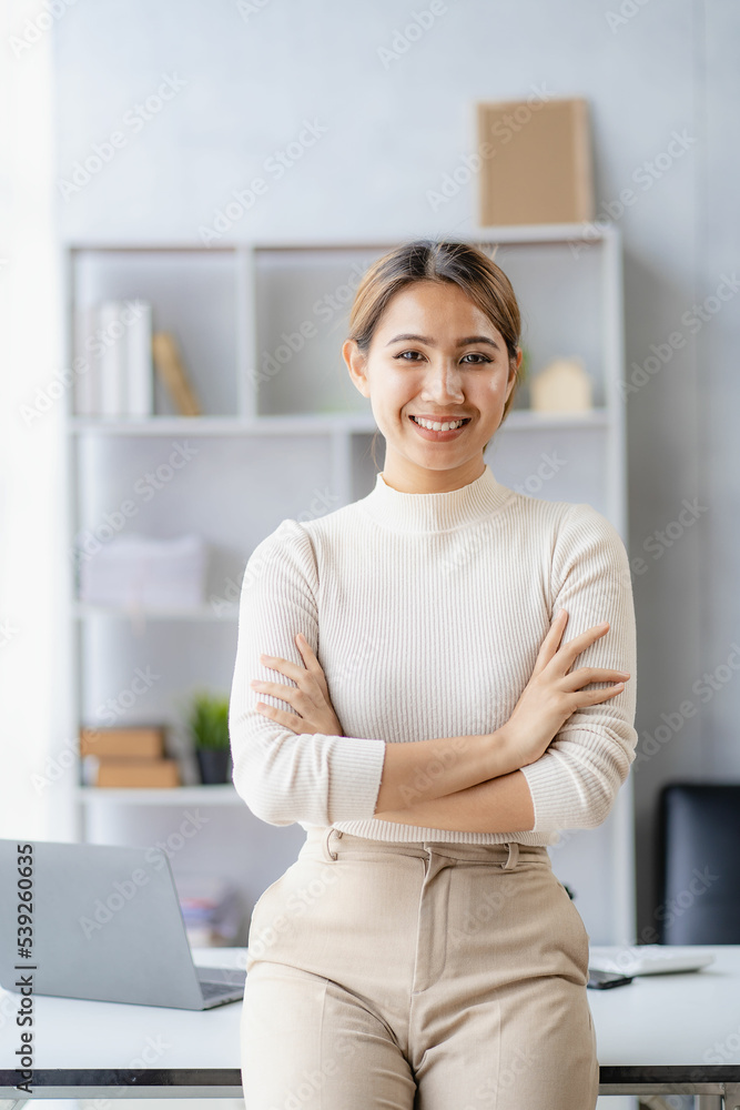 © ArLawKa - Independent Asian woman working from home Business woman using laptop sitting on a desk in home office, lifestyle concept, woman working online on the internet. © ArLawKa - Independent Asian woman working from home Business woman using laptop sitting on a desk in home office, lifestyle concept, woman working online on the internet.