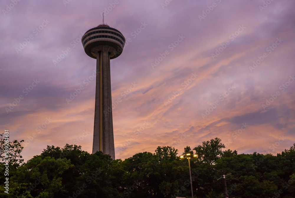 The observation tower and the beautiful sky in the at sunset with pink clouds. 