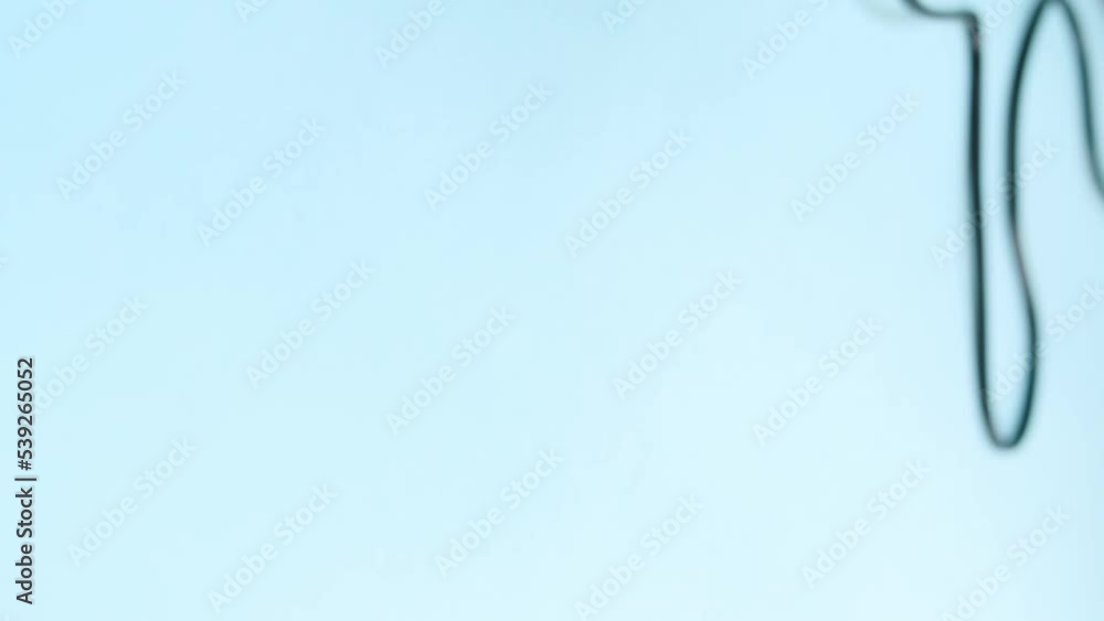 Vertical video of hand holding a blue hair dryer on blue background Vertical video of hand holding a blue hair dryer on blue background