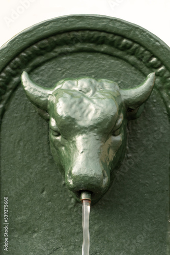 Traditional fountain of Turin town, Italy. The bull is the symbol of the town photo