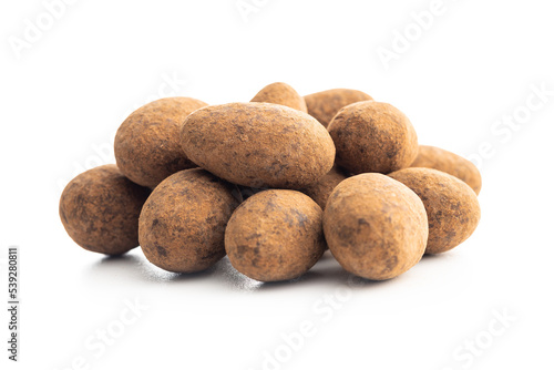 Almonds in chocolate coated in cocoa powder isolated on white background.