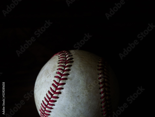 Baseball photographed in natural light with a dark background