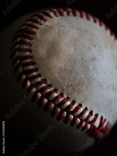 Baseball photographed in natural light with a dark background