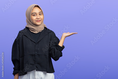 Asian Muslim Woman Pointing at Copy Space, Isolated